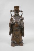 A Chinese carved hardwood figure of a dignitary carrying a ruyi, A/F repair to hand, 12" high