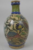 An Iznik pottery bulbous vase painted with fish amongst flowering plants, 8½" high