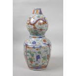A Chinese wucai porcelain double gourd vase decorated with dragons, lotus flowers and boys at
