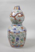 A Chinese wucai porcelain double gourd vase decorated with dragons, lotus flowers and boys at