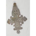 A bronze age pendant cross with ornate pierced and engraved decoration, 3" long