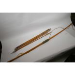 A vintage wooden bow and a quantity of metal tipped arrows with feather flights, bow 60" long