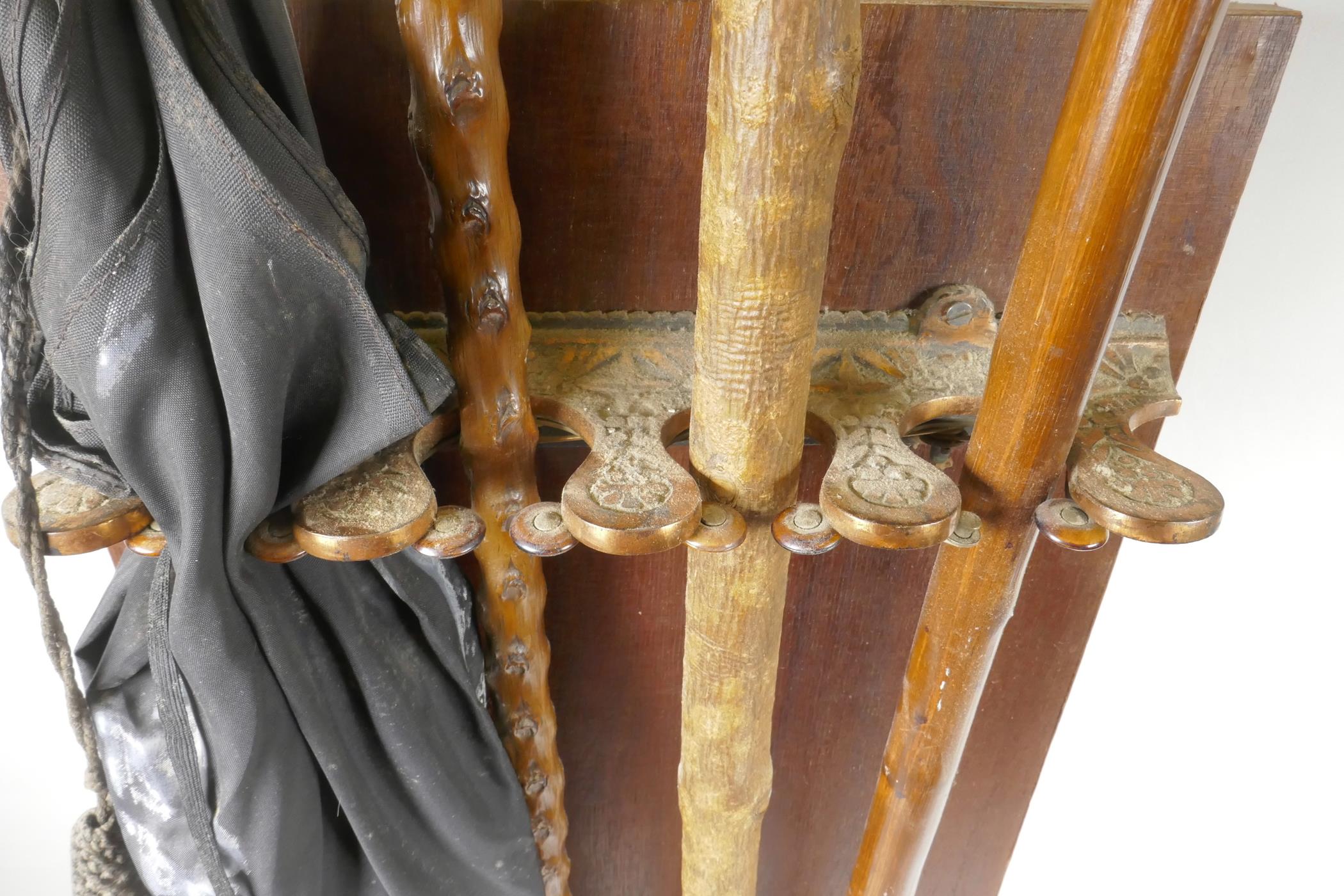 A C19th wall mounted stick stand with patent locking mechanism containing three walking sticks and - Image 2 of 5