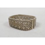 A Chinese white metal bangle with knotted decoration, 2" x 2½"