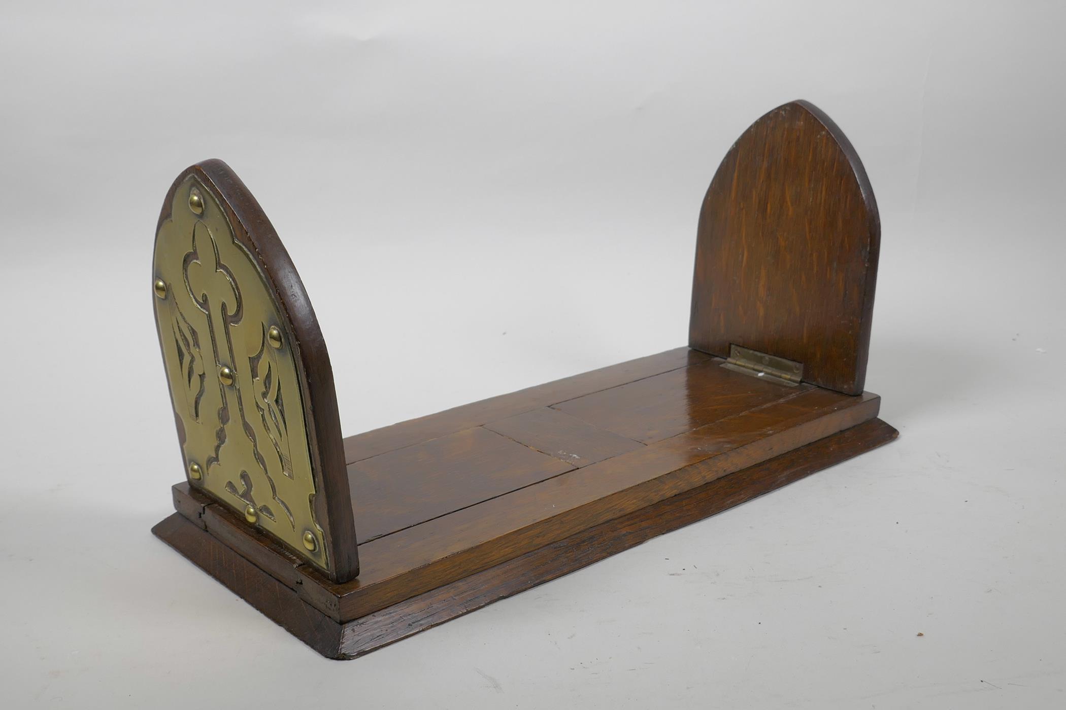 A Gothic oak book slide with decorative brass mounts to end, 13" long collapsed