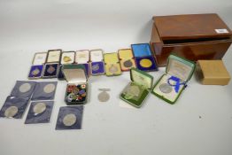 A box of various medals, badges and commemorative coins including 1832 Silver swimming medal, 1939-