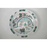 A Chinese famille verte porcelain charger decorated with figures in a landscape, 6 character mark to