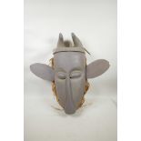 An African painted wood horned mask with large ears, 21½" high