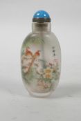 A Chinese reverse decorated snuff bottle depicting birds amongst flowers and gourds, 3½" high