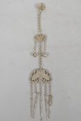 A Chinese white metal chatelaine pendant with bat and butterfly decoration, 13½" drop