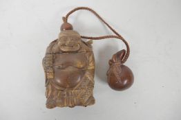 A Japanese carved boxwood inro in the form of a rotund Buddha, 3" long