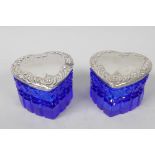 A pair of heart shaped blue glass dressing pots with sterling silver lids, 2" high, 2½" wide