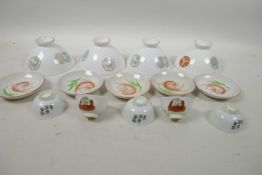 Four Chinese porcelain rice bowls decorated with small floral panels, together with five porcelain