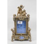 A C19th French style gilt bronze mantel clock, with winged putti decoration and inset enamelled