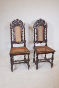 A pair of C19th French oak high back chairs with carved griffin decoration and caned seats and