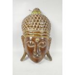 An Indian carved and gilt Buddha mask, 9" x 15"