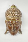 An Indian carved and gilt Buddha mask, 9" x 15"