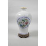 A Chinese porcelain meiping vase with decorative famille verte enamelled panels depicting flowers in
