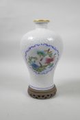 A Chinese porcelain meiping vase with decorative famille verte enamelled panels depicting flowers in