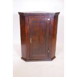 A C19th oak single hanging corner cupboard with shaped shelving, 40" high, 20½" to corner, 31½"