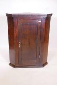 A C19th oak single hanging corner cupboard with shaped shelving, 40" high, 20½" to corner, 31½"