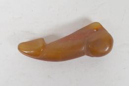 A carved agate phallic pendant, 2½" long