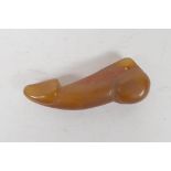 A carved agate phallic pendant, 2½" long