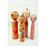 Four Japanese painted wooden kokeshi dolls, largest 12" high