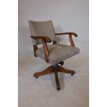 A 1930s oak swivel office chair