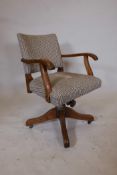 A 1930s oak swivel office chair