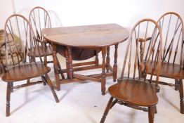 An oak drop leaf oval top table, 38" long, 29" high, together with a set of four (two plus two)