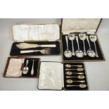 A boxed set of six hallmarked silver rattail tea spoons, 70g, together with a boxed pair of fish