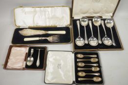 A boxed set of six hallmarked silver rattail tea spoons, 70g, together with a boxed pair of fish