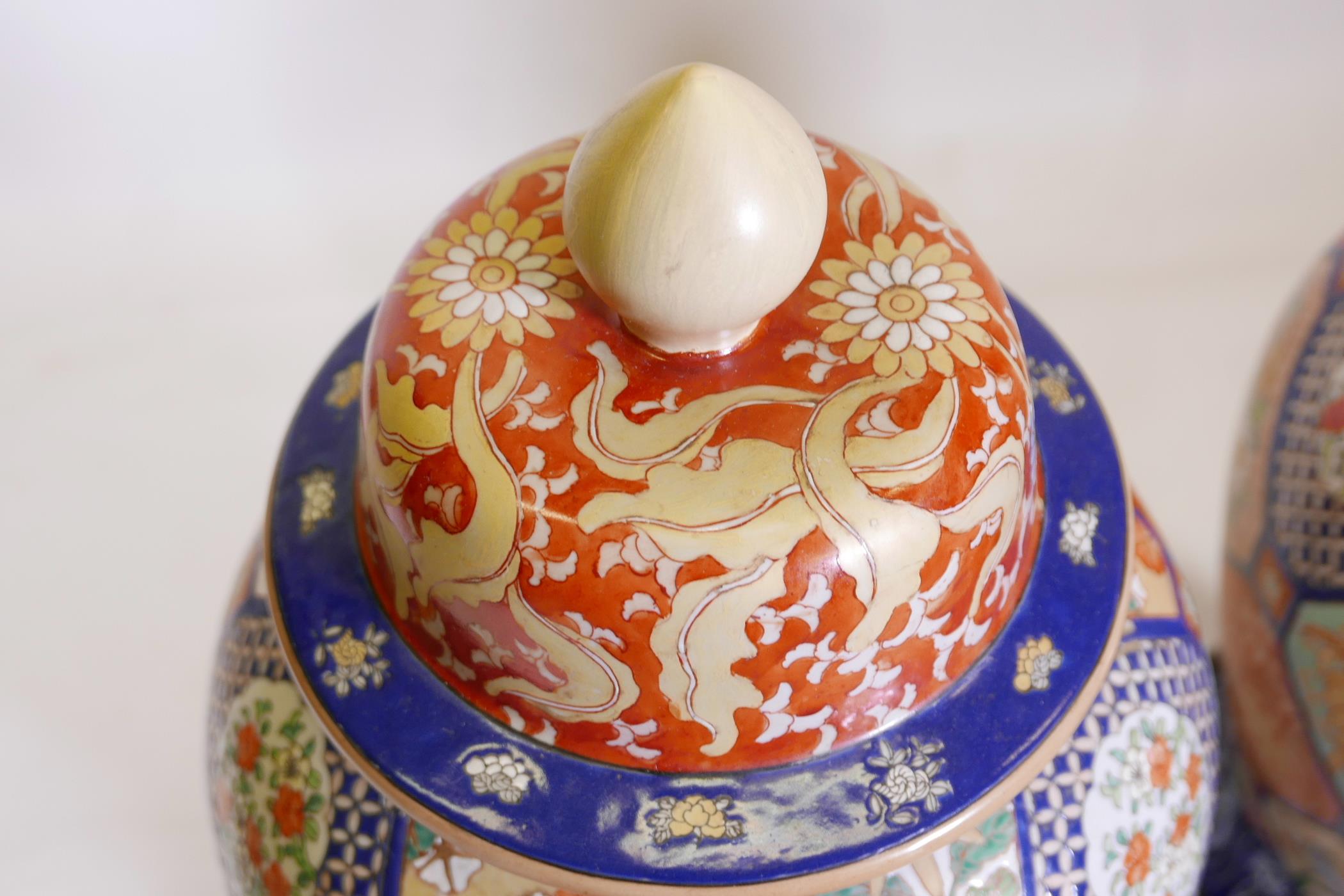 A pair of Oriental ceramic jars and covers, decorated with bright enamels in the Imari style, with - Image 5 of 5