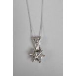 An 18ct white gold, star shaped and diamond set pendant necklace