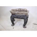 A C19th carved fluorspar tray/bowl on a carved and lacquered wood stand with dragon mask decoration,
