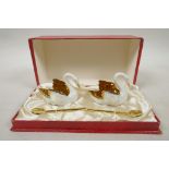 A 1950s Limoges swans porcelain cruet set consisting of two swans with white glaze inlaid with