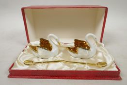 A 1950s Limoges swans porcelain cruet set consisting of two swans with white glaze inlaid with