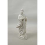 A blanc de chine robed figure carrying a sword, 9½" high