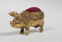 A brass pincushion in the form of a pig, 1½" long