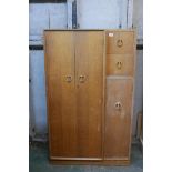 An Art Deco oak compactum, with three cupboards and two drawers, the top one fitted with a