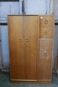 An Art Deco oak compactum, with three cupboards and two drawers, the top one fitted with a