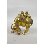 A Chinese gilt bronze of two boys riding a buffalo, 5½" high