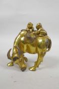 A Chinese gilt bronze of two boys riding a buffalo, 5½" high