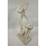 An abstract pottery figure of a seated lady, 11" high