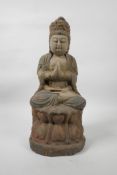 A Chinese painted and distressed carved wood Buddha seated on a lotus throne, 14½" high