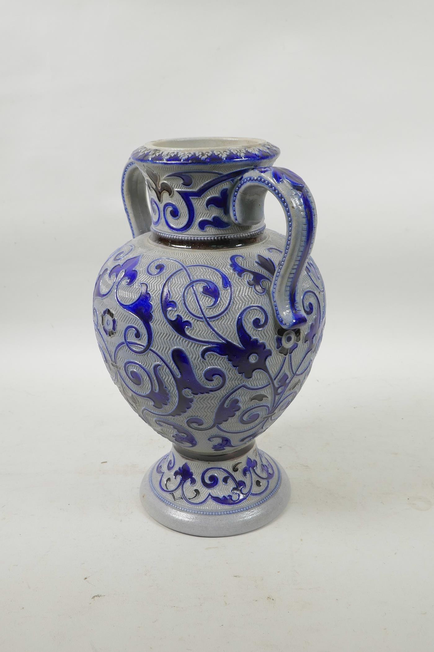 A German salt glazed pottery urn with scrolling blue foliate decoration, 11" high - Image 2 of 4