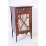 A Victorian walnut music cabinet with single drawer, the front with carved Gothic tracery over
