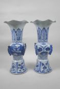 A pair of Chinese blue and white porcelain Gu shaped vases with frilled rims, decorated with birds