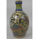 An Iznik pottery bulbous vase painted with fish amongst flowering plants, 8½" high